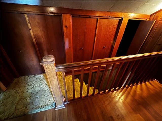 stairs featuring hardwood / wood-style floors