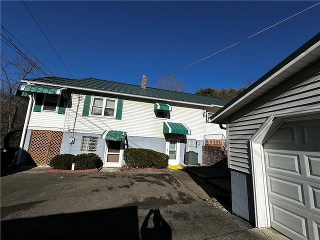 view of side of home featuring a garage