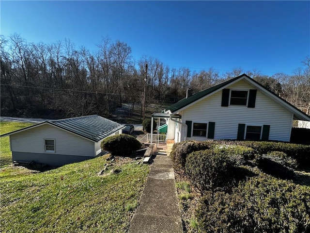 view of side of home featuring a yard