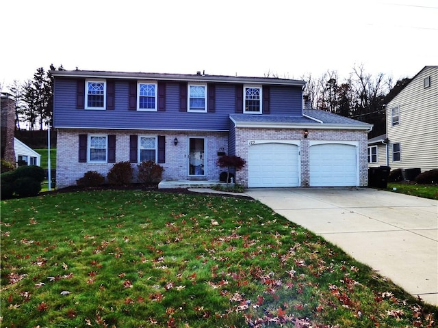 view of front of home featuring a front yard and a garage