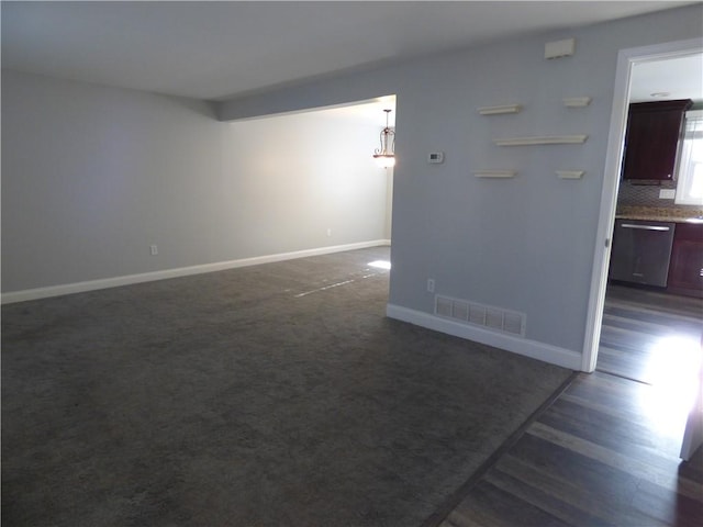 spare room with dark hardwood / wood-style floors