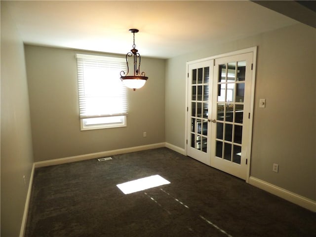 unfurnished dining area with french doors and dark carpet