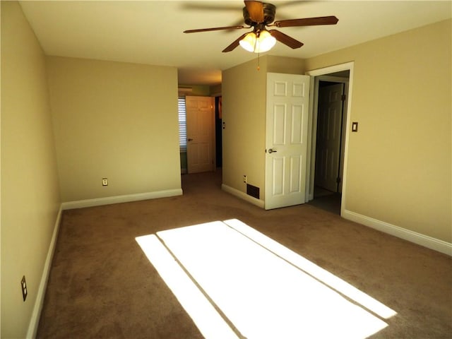 unfurnished bedroom featuring dark carpet and ceiling fan