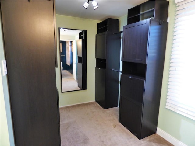 interior space with plenty of natural light and light colored carpet