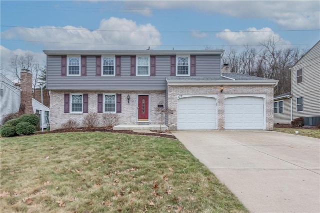 view of front facade featuring a garage, central AC, and a front lawn