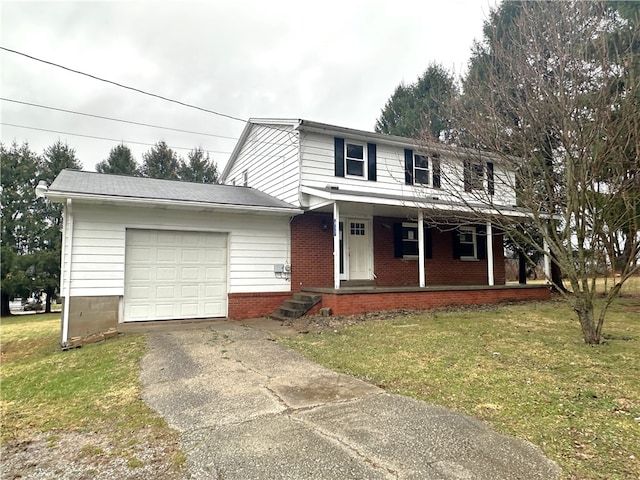 view of front of house featuring a porch, a garage, and a front lawn