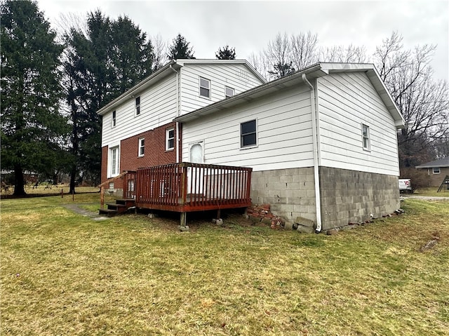 back of house with a deck and a lawn