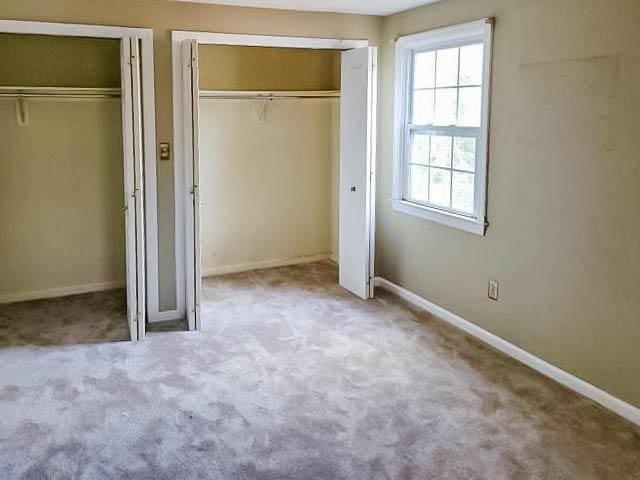 unfurnished bedroom with light carpet