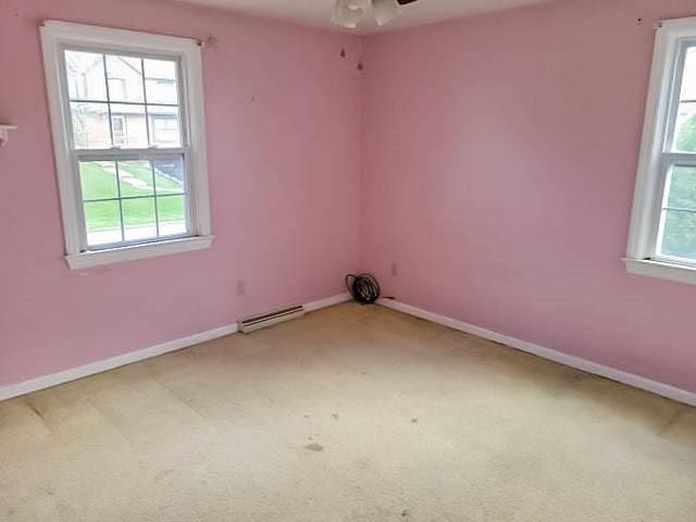 carpeted spare room featuring ceiling fan