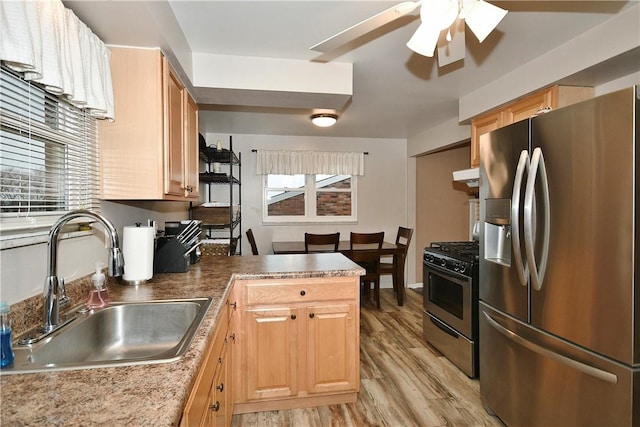 kitchen featuring ceiling fan, sink, light hardwood / wood-style floors, exhaust hood, and appliances with stainless steel finishes