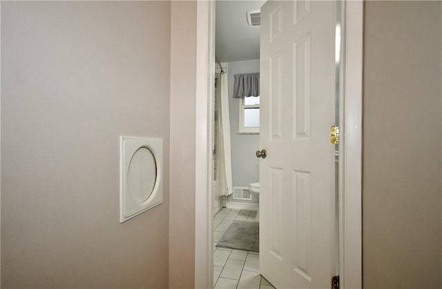 hall featuring light tile patterned flooring