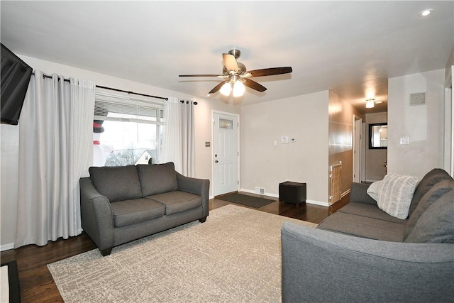 living room featuring dark hardwood / wood-style floors and ceiling fan