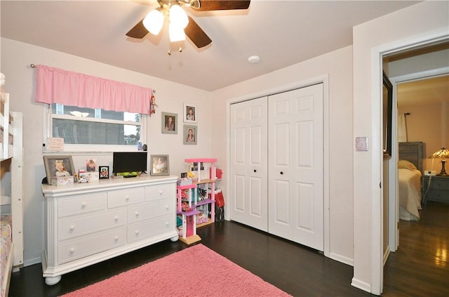 bedroom with a closet, dark hardwood / wood-style floors, and ceiling fan