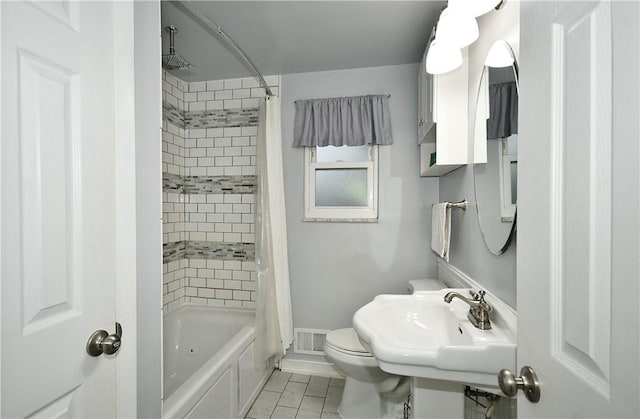 full bathroom with toilet, sink, tile patterned flooring, and shower / tub combo with curtain