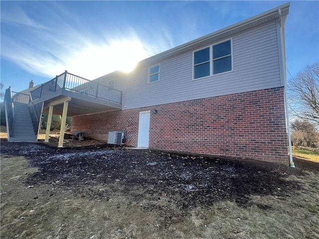 view of home's exterior featuring a wooden deck and central AC unit