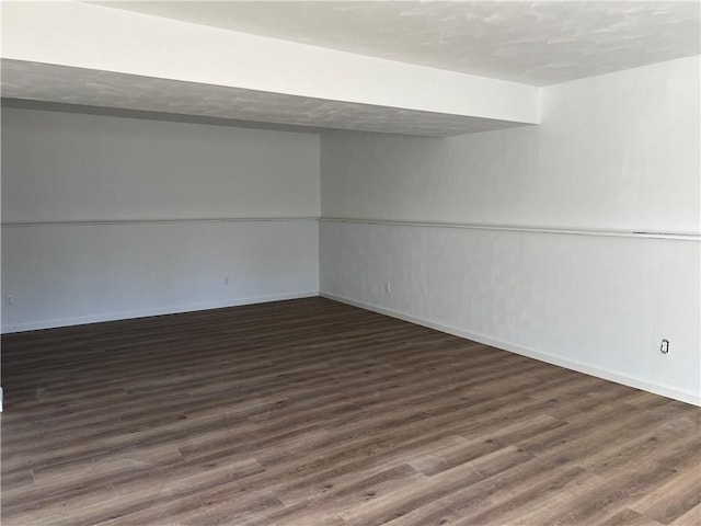 basement with dark hardwood / wood-style flooring