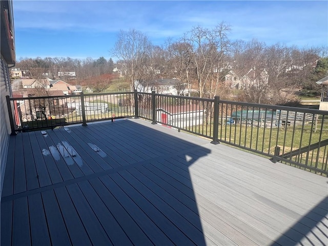 wooden terrace featuring a yard