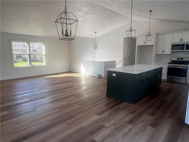 kitchen featuring white cabinetry, hanging light fixtures, stainless steel appliances, and a center island