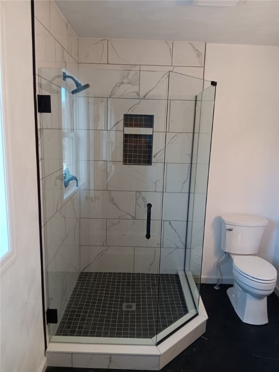 bathroom with walk in shower and toilet