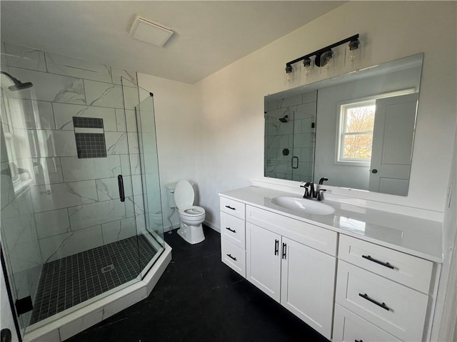 bathroom with vanity, an enclosed shower, and toilet