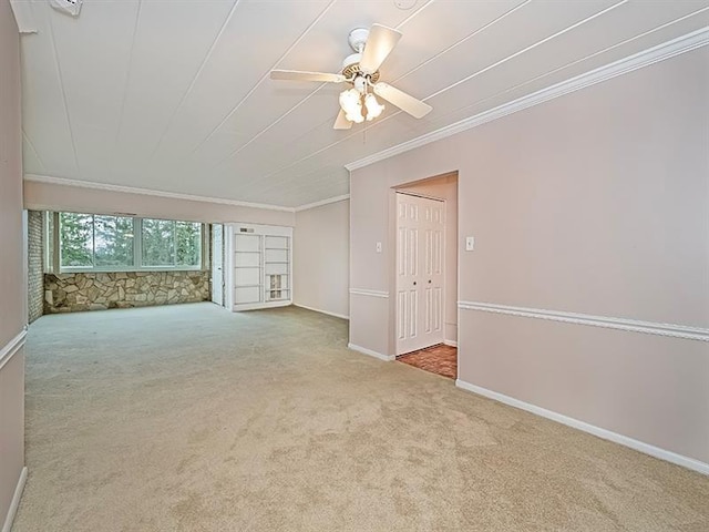 unfurnished room with light colored carpet, ceiling fan, and crown molding