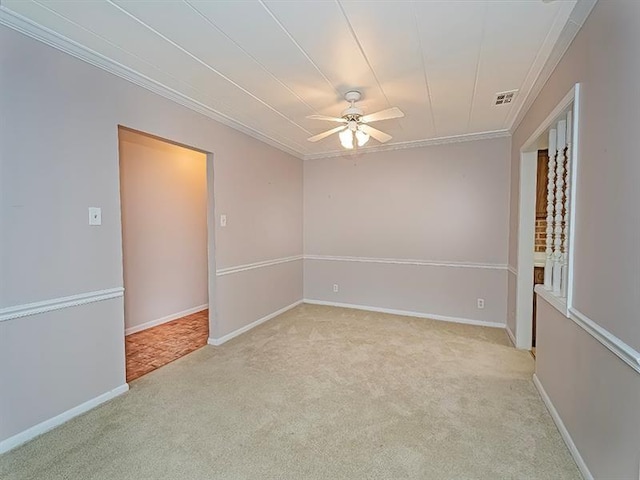 unfurnished room featuring ceiling fan, ornamental molding, and light carpet