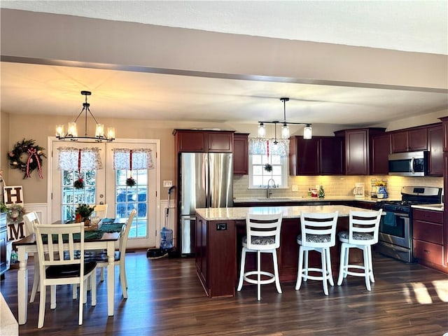 kitchen featuring pendant lighting, a center island, and stainless steel appliances