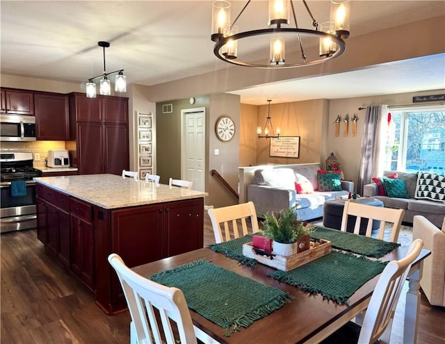 dining space with an inviting chandelier and dark wood-type flooring