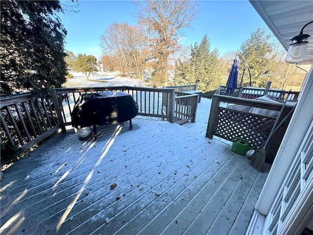 wooden deck with a grill