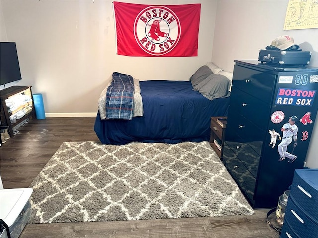 bedroom with dark hardwood / wood-style flooring