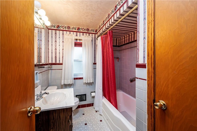 full bathroom featuring vanity, tile patterned floors, toilet, shower / bathtub combination with curtain, and tile walls