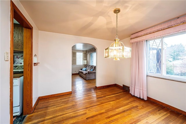 unfurnished dining area featuring wood-type flooring