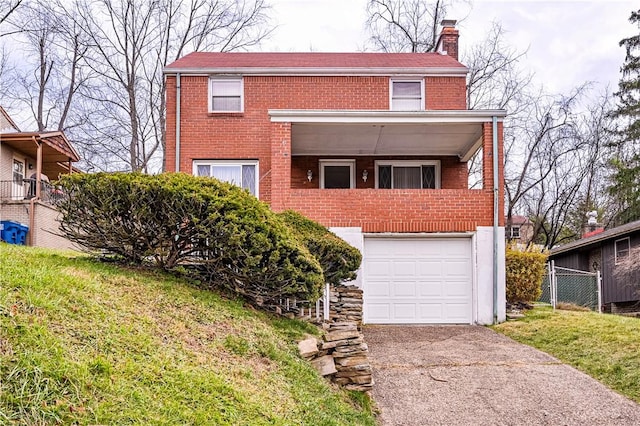 view of front of home with a garage, a chimney, concrete driveway, and brick siding