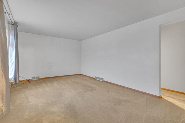 unfurnished room featuring light colored carpet