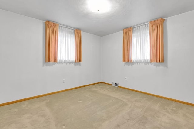 unfurnished room featuring carpet flooring