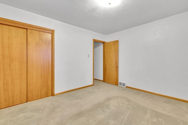 unfurnished bedroom with carpet and a closet