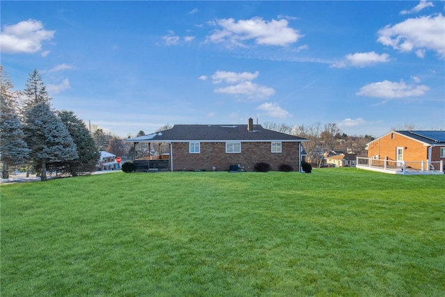 rear view of house with a yard