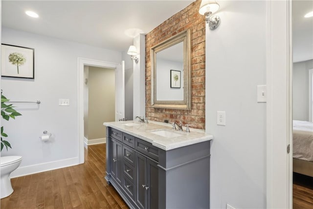 bathroom with hardwood / wood-style flooring, vanity, and toilet