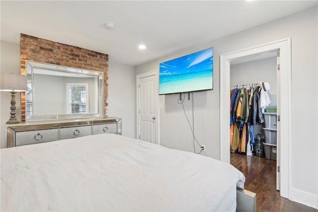 bedroom with a closet and dark wood-type flooring