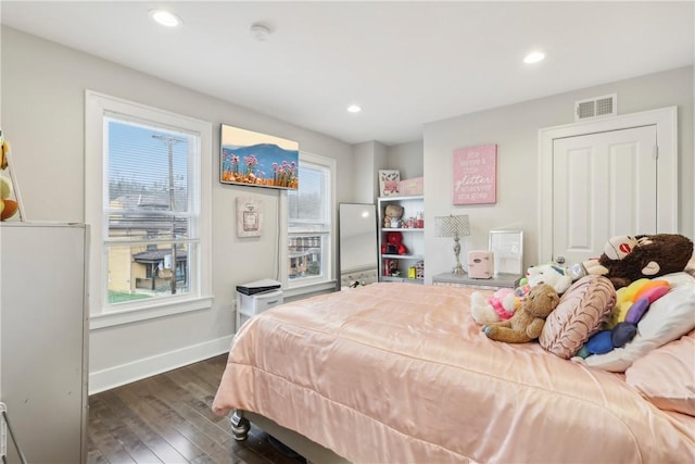 bedroom with dark wood-type flooring