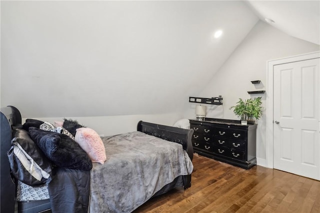 bedroom with lofted ceiling and dark wood-type flooring