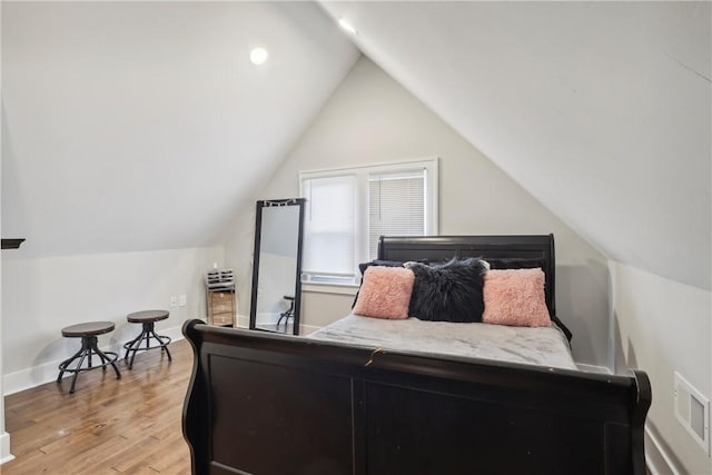 bedroom featuring vaulted ceiling and light hardwood / wood-style flooring