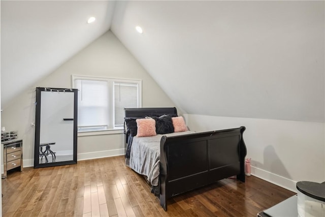 bedroom featuring vaulted ceiling and hardwood / wood-style flooring