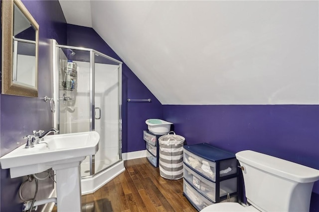 bathroom featuring hardwood / wood-style floors, toilet, an enclosed shower, and lofted ceiling