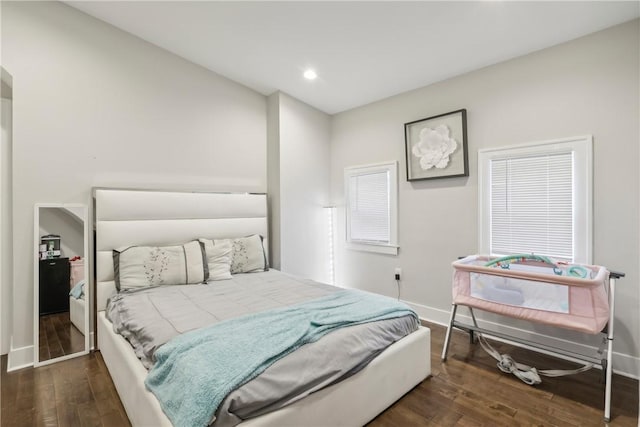 bedroom with dark hardwood / wood-style flooring