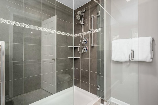 bathroom featuring a shower with shower door