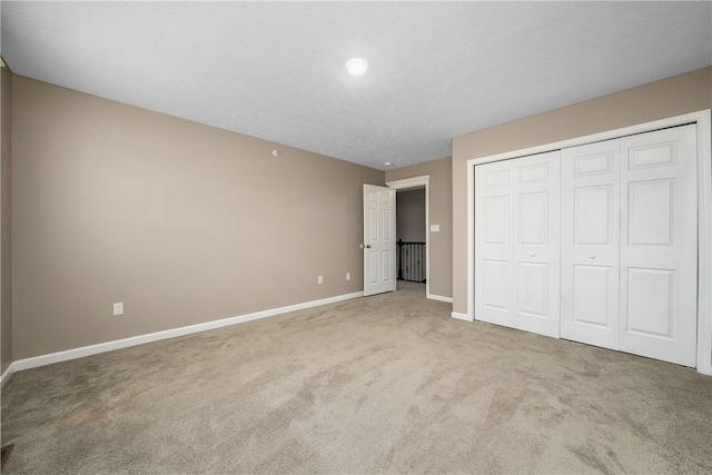 unfurnished bedroom with a closet and carpet