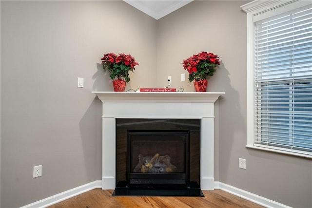 interior details with wood-type flooring and ornamental molding