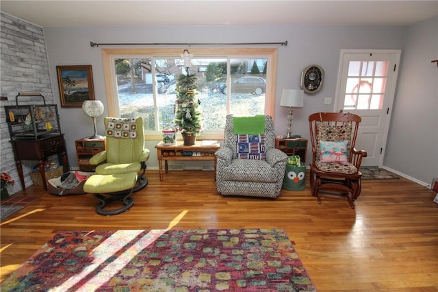 sitting room featuring hardwood / wood-style floors and a healthy amount of sunlight