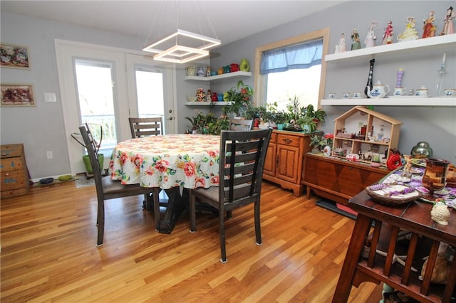 dining room with a wealth of natural light and light wood-type flooring